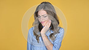 Toothache, Young Girl with Tooth Pain Isolated on Yellow Background
