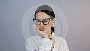 Toothache. Young woman feeling pain, holding her cheek with hand, suffering from bad tooth ache, isolated on gray studio