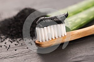 Toothbrush with black charcoal toothpaste with aloe vera photo