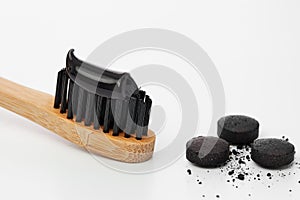 Toothbrush with black charcoal toothpaste photo