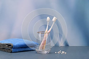 Toothbrush stands in a glass on a blue background