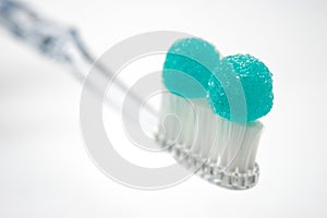 Toothbrush with sweets, concept of health and dental care and unhealthy sugar abuse