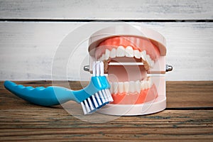 Toothbrush and teeth pattern on a wooden background. Tooth brushing and health concept