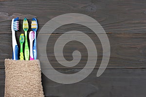 Toothbrush tooth-brush with bath towel on wooden table. top view with copy space