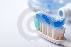 Toothbrush and toothpaste on blurred background