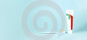 Toothbrush and toothpaste on blurred blue background. Oral Care Concept. Concept of oral hygiene in the family
