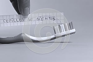 Toothbrush written on a small paper, cepillos de dientes in Spanish photo