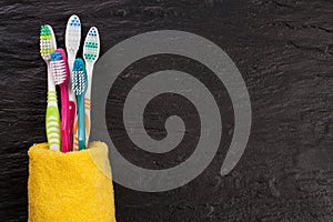 Toothbrushes on the black stone background with copy space for your text. Top view