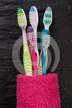 Toothbrushes on the black stone background