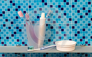 Toothbrushes and dentifrice on a shelf