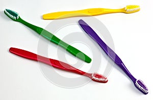 Four colourful toothbrushes.