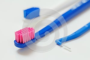 Toothbrushes and interdental brush on the white background.