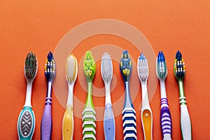 Toothbrushes on a orange background. Concept toothbrush selection. Oral cavity care. Dental hygiene