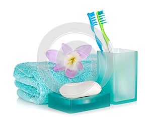 Toothbrushes, soap, towel and flower