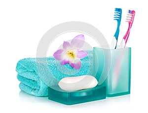 Toothbrushes, soap, towel and flower