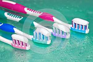 Toothbrushes in water drops