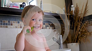 Toothbrushing background. Toothbrush and baby. First teeth. Toothpaste for milk teeth. Baby brushing the teeth in
