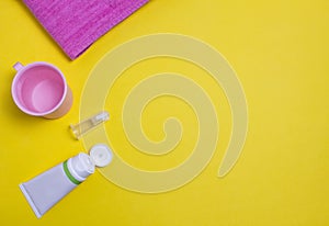 Toothpaste and brush for the youngest children, yellow background