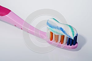 Toothpaste on toothbrush isolated on white background