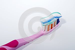 Toothpaste on toothbrush isolated on white background