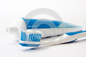 Toothpaste on a toothbrush with a tube