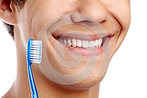 Toothy smile with brush closeup