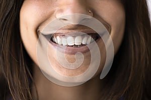 Toothy smile close up of happy young Indian woman