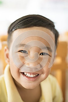 Toothy smiling face happiness emotion of asian children shallow