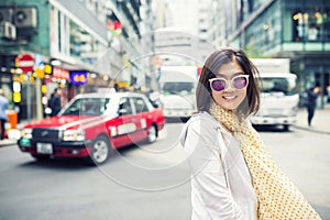 Toothy smiling face happiness emotion of asian woman standing on hongkong city street