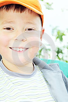 Toothy smiling kid outdoors