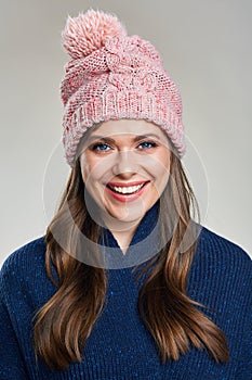 Toothy smiling woman portrait wearing winter scarf and hat.