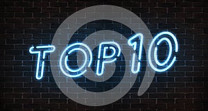 Top 10 neon light text on empty red brick wall banner. Bright neon sign of top ten list winners at night. Design template of moder