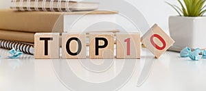 Top 10 sign made of wooden dices on a table i a bright environment