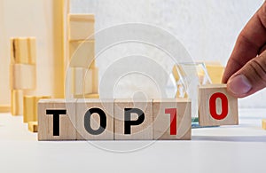 Top 10 sign made of wooden dices on a table i a bright environment with blue colors