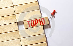 Top 10 sign made of wooden dices on a table i a bright environment with blue colors