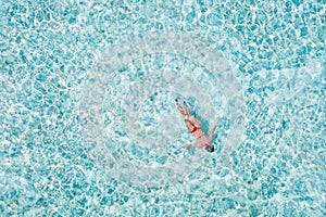 Top above high angle aerial drone view of her she girl diving pure blue clean clear ocean water pool poolside enjoying