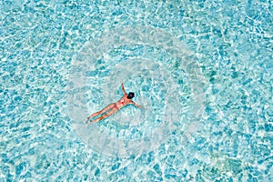 Top above high angle aerial drone view of her she pure blue perfect clean clear ocean water pool girl diving enjoying