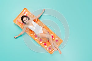 Top above high angle full size photo of positive girl enjoy recreation resort swim lay inflatable orange mattress ocean