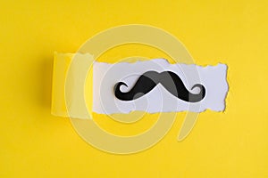 Top above overhead view photo of hipster moustache and torn yellow paper over white background with copyspace