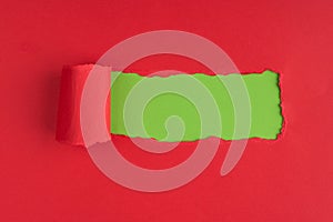Top above overhead view photo of torn red paper over green background with copyspace