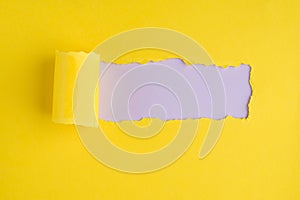 Top above overhead view photo of torn yellow paper over light lilac background with copyspace