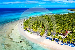 Top aerial drone view of beautiful beach with turquoise sea water, boats and palm trees. Saona island, Dominican republic. photo