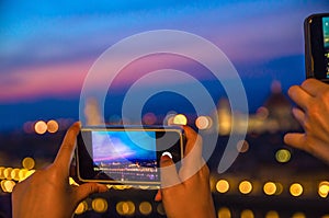 Top aerial panoramic evening view of Florence city with Duomo through screen of mobile phone at dusk