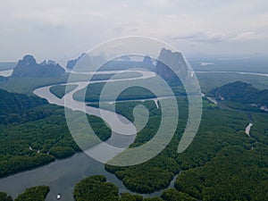 Top and aerial view in area of NAI HGOP pier of Ao Phang - Nga in Thailand show line of water with mangroves along the sides and