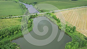 Top Aerial View of Big Lake and Fields. Pond, Farm, Rural Scenery Farmland Trees. Aerial View.