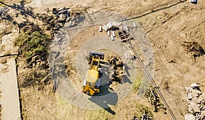 Top aerial view of big wheel loader excavator bulldozer work on a building project f