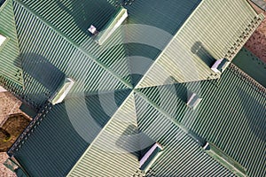 Top aerial view of building green shingle tiled roof construction. Abstract background, geometrical pattern