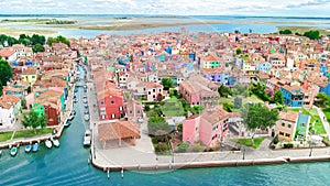 Aerial view of colorful Burano island in Venetian lagoon sea from above, Italy