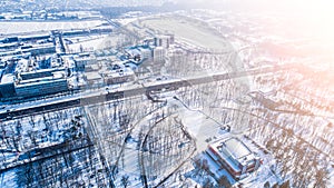 Top aerial view of empty city park in winter with snow