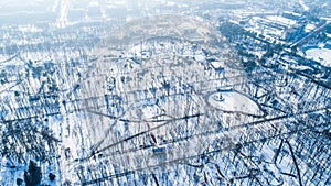 Top aerial view of empty city park in winter with snow